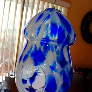 Blown blue glass to hang outside or inside to put an air plant in .